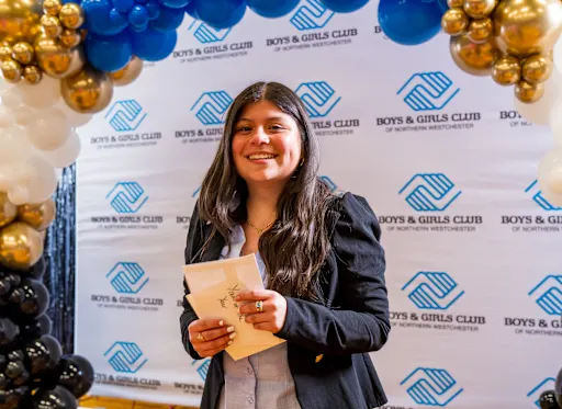 Beberlyn stands in front of a Boys and Girls Club backdrop