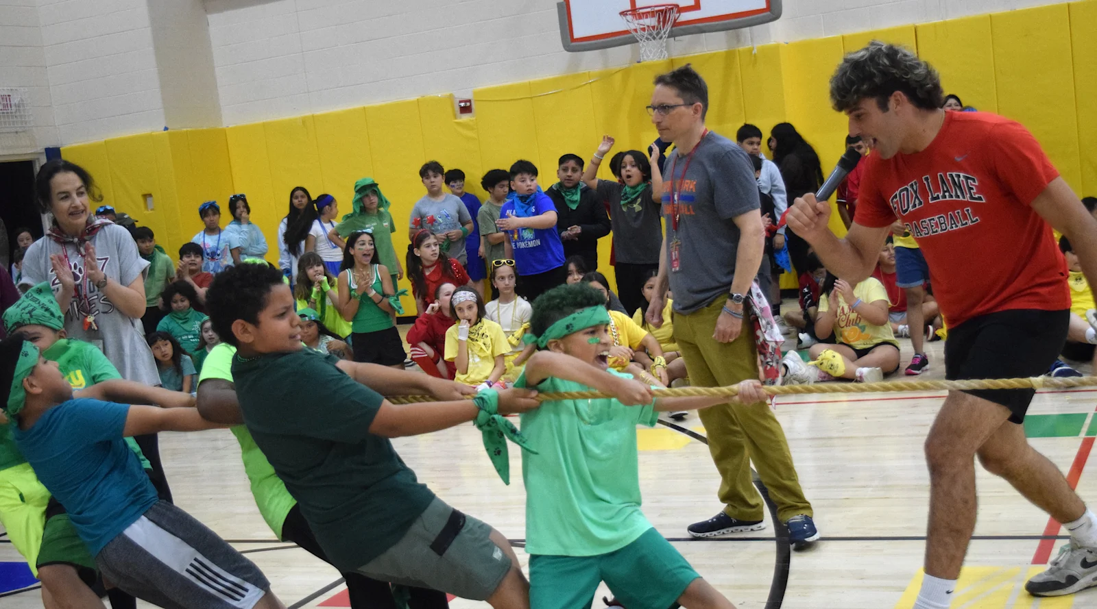 students play tug of war while others cheer them on